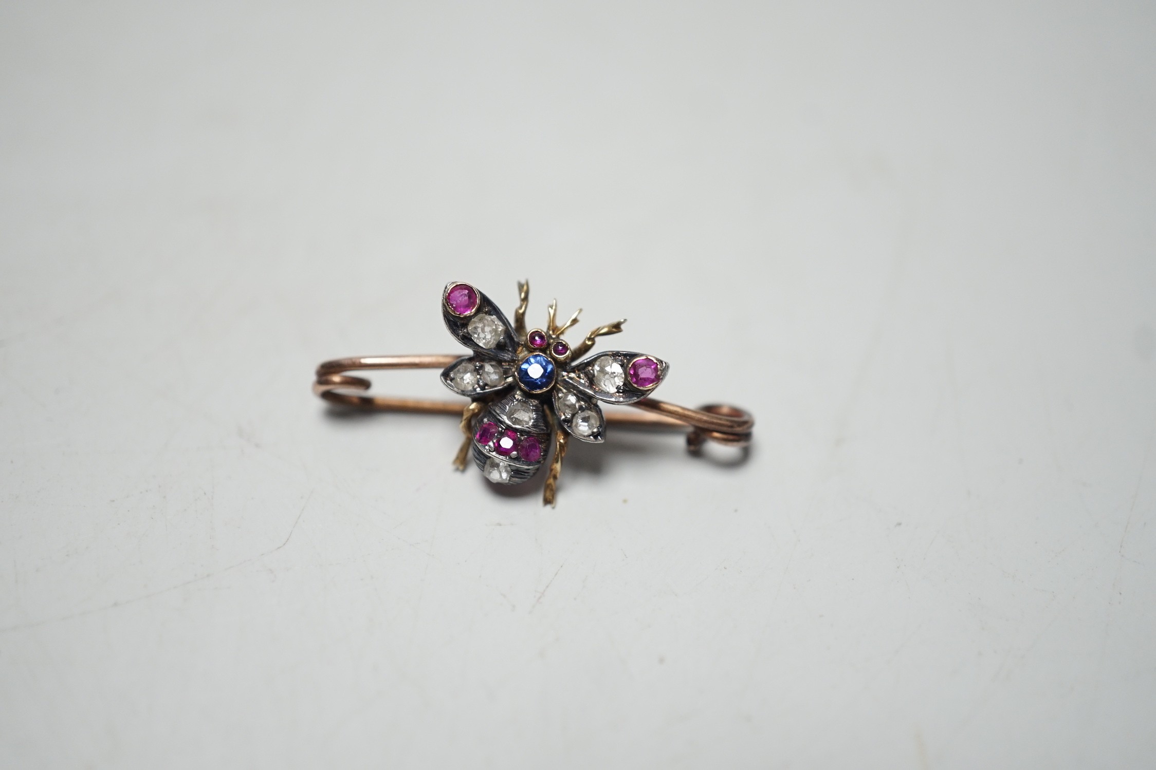 A late Victorian yellow metal, ruby, sapphire and diamond set bug brooch, 30mm, gross weight 2.2 grams.